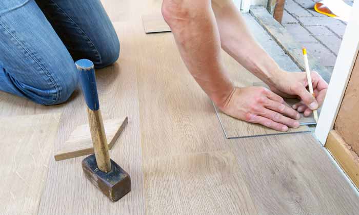 Laminate wood flooring being installed during home remodeling project