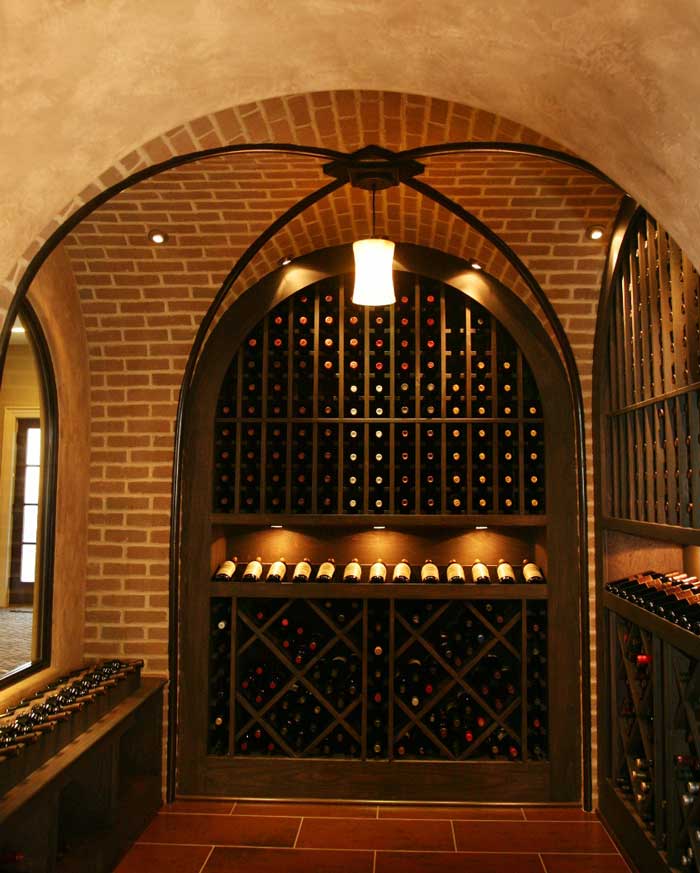 Vintage wine cellar with groin vault, wall niche, and archway opening from Cua builders