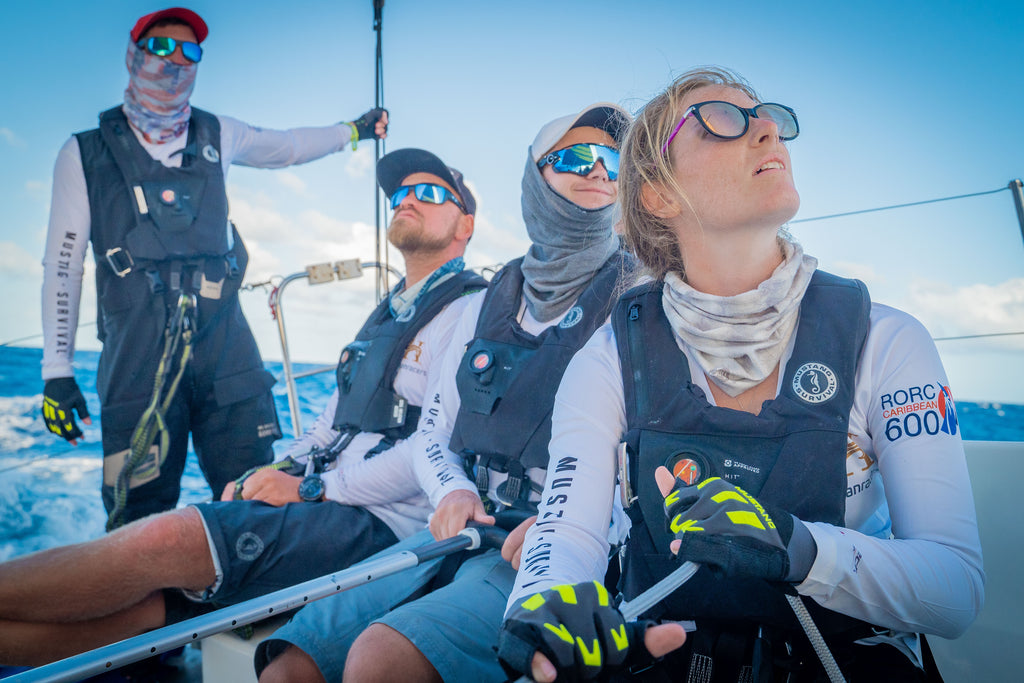 close up of four young people racing yacht