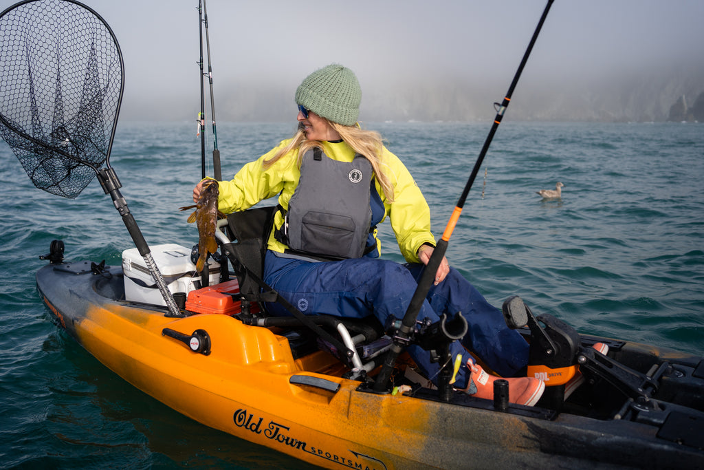 Annie in kayak holding rock fish