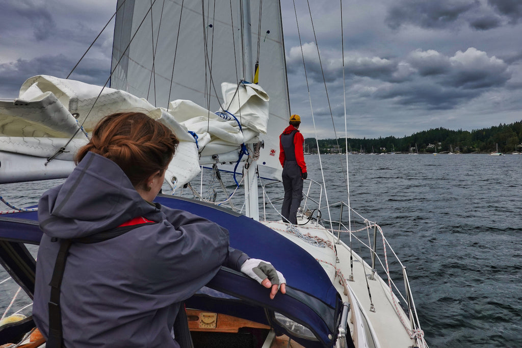 two young sailors embarking on first open ocean voyage under ominous skies 