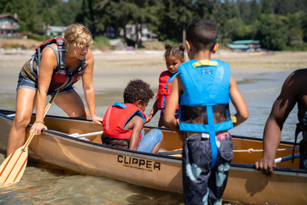 Family getting into canoe, destiny vest featured