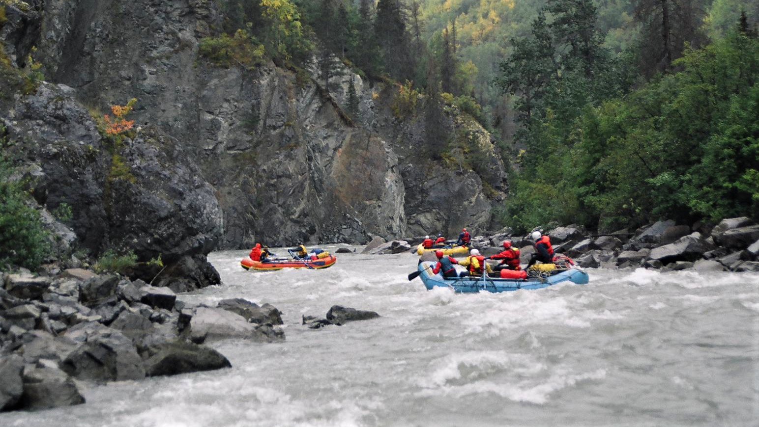 rafts navigating through whitewater conditions