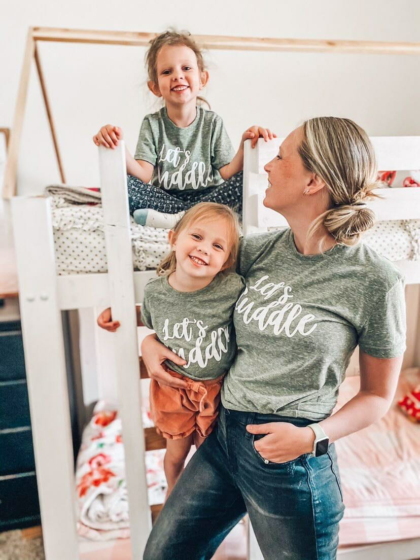 Mom and two kids wearing matching tees that say Let’s cuddle