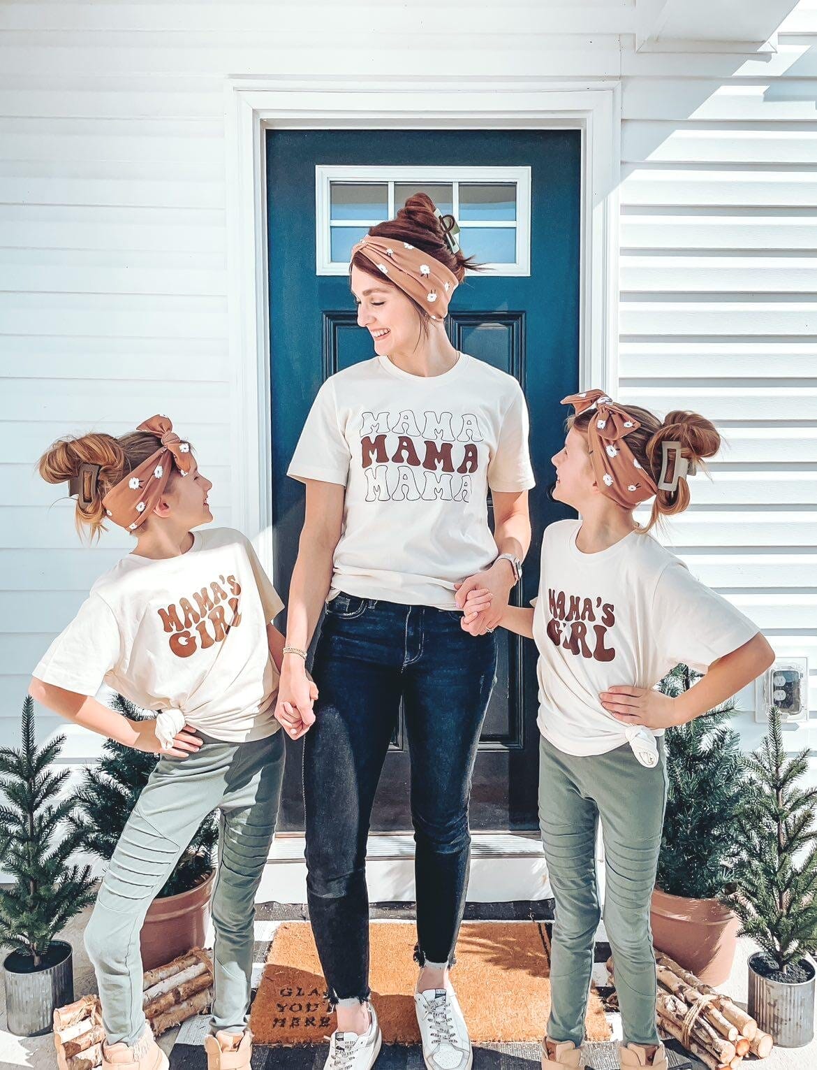 A mom and her two girls wearing matching outfits