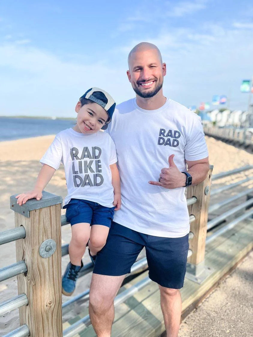 A dad and son wearing matching father and son T-shirts