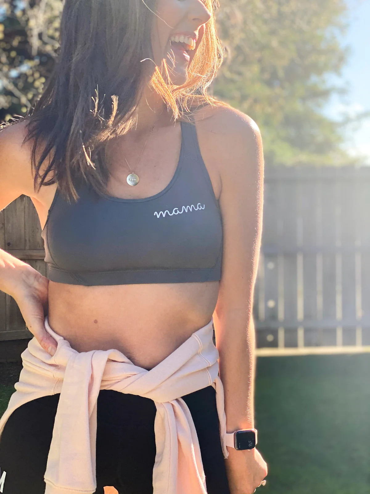 A woman wearing a sports bra that says Mama