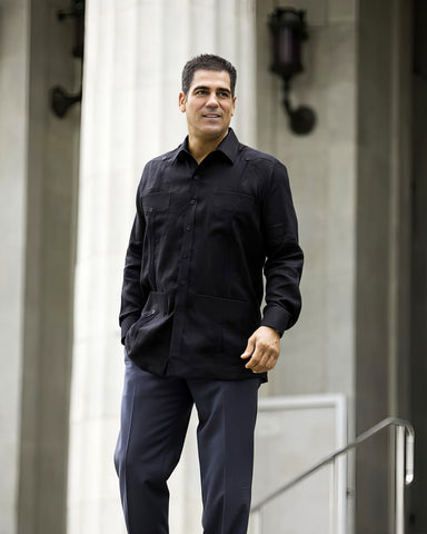 Man-wearing-black-pants-and-a-black-Ramon-Puig-guayabera.