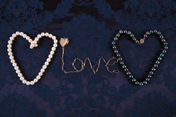 Heart from pearls combined with love on dark background