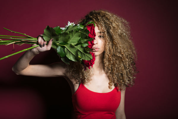 Woman in red dress with red roses