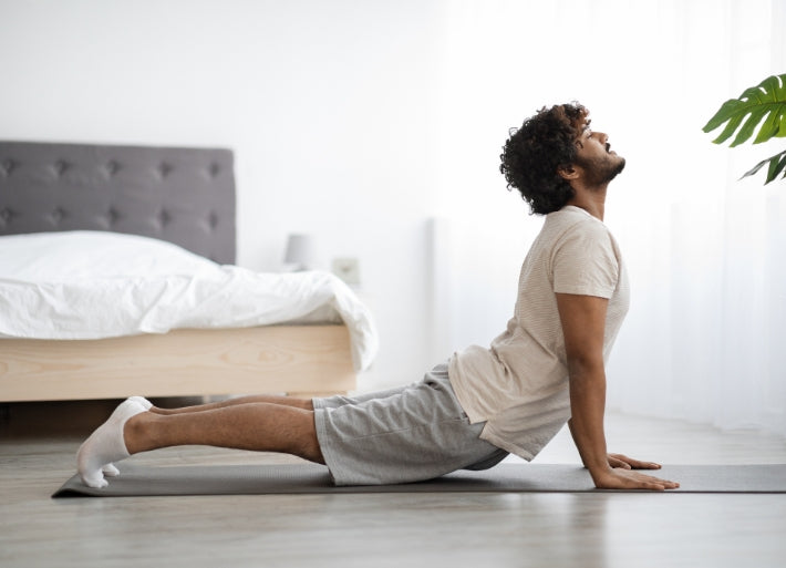 Athletic man stretching at home