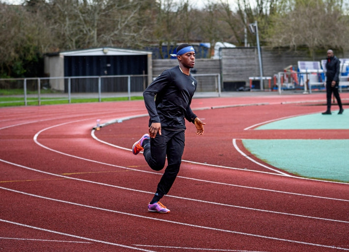 Destiny Ogali sprinting at athletics stadium