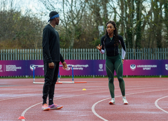 Destiny Ogali talking to female sprint athlete
