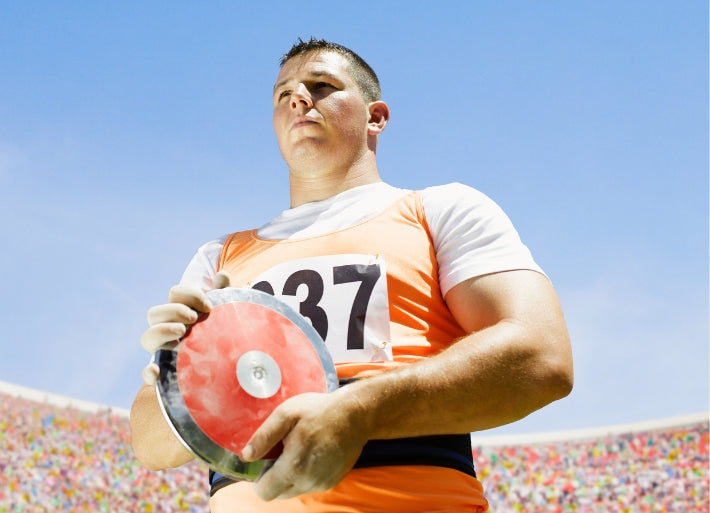 Male discus throws athlete in stadium