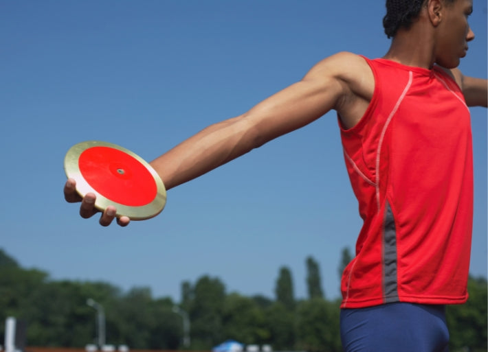 Male throws athlete in athletics training