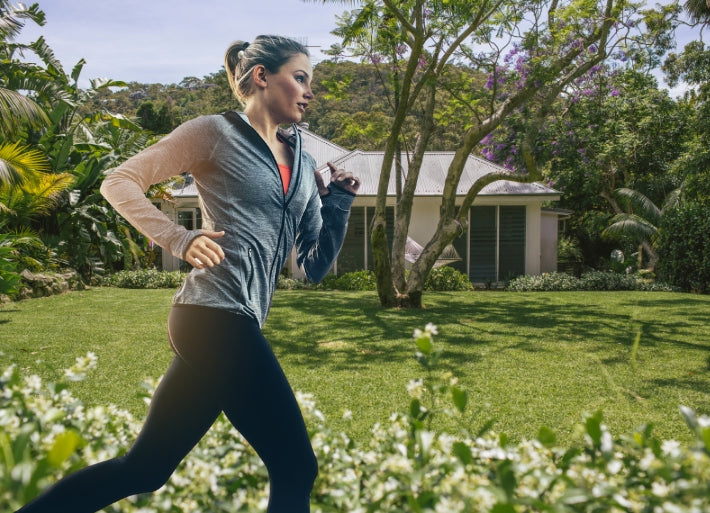 Female athlete running in garden