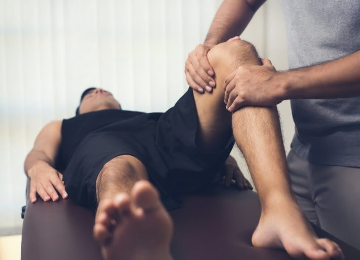 Physiotherapist Treating Male Athlete Patient