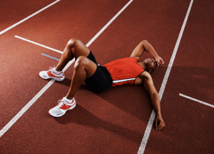 Tired Athlete Lying on Track