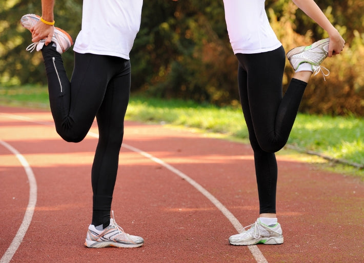 Athletes Stretching on Athletics Track