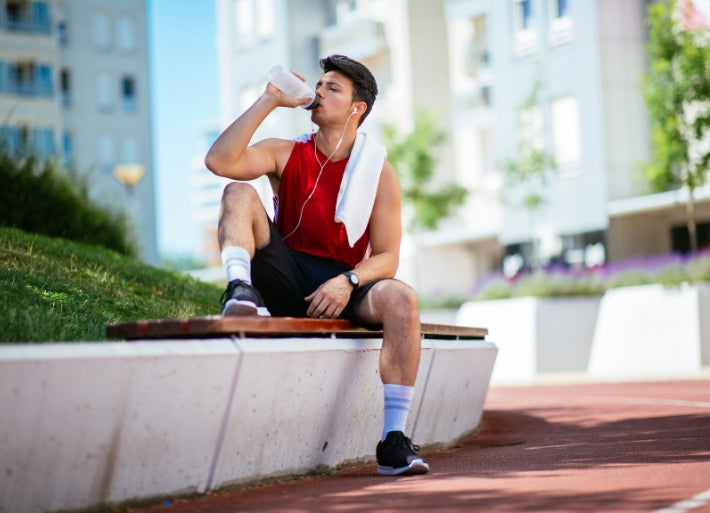 Male Athlete Drinking Water after Training