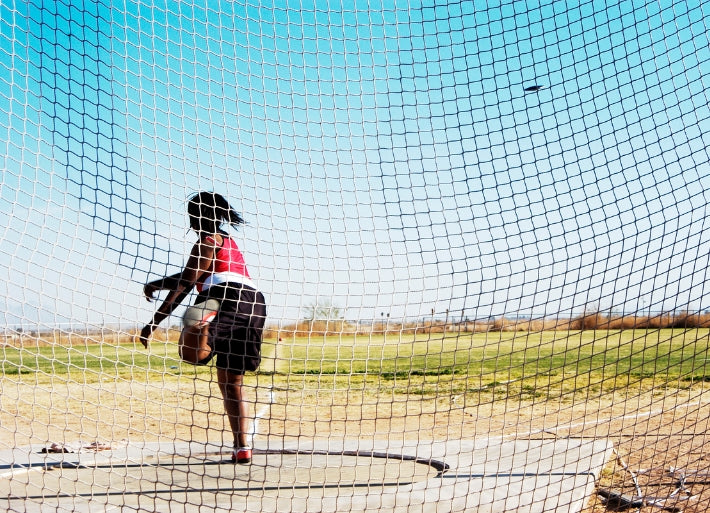 Female Athlete in Discus Training