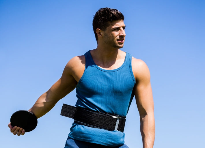 Male discus athlete in athletics stadium