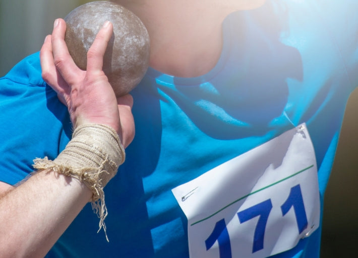 Male athlete preparing to throw shot put