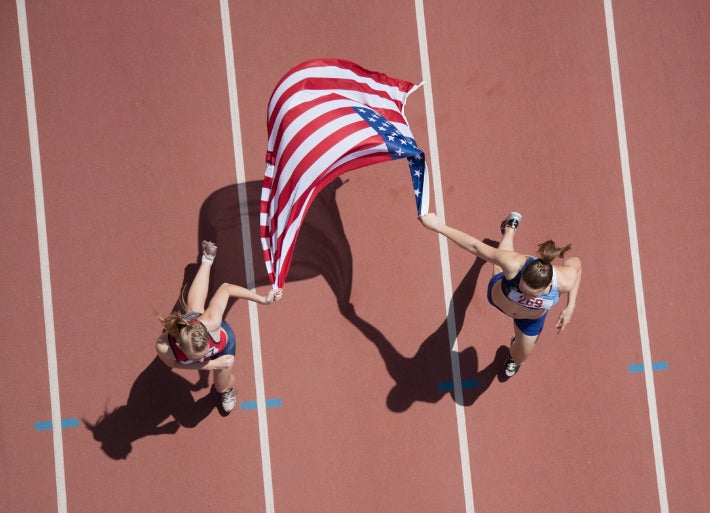 Runners Celebrating on Track with American flag