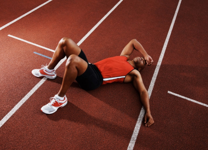 Tired male athlete on track