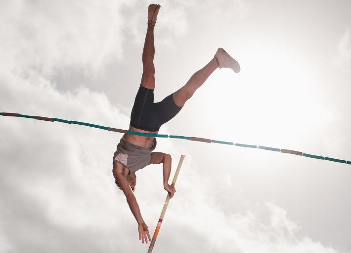 Male Pole Vaulter in Mid Air
