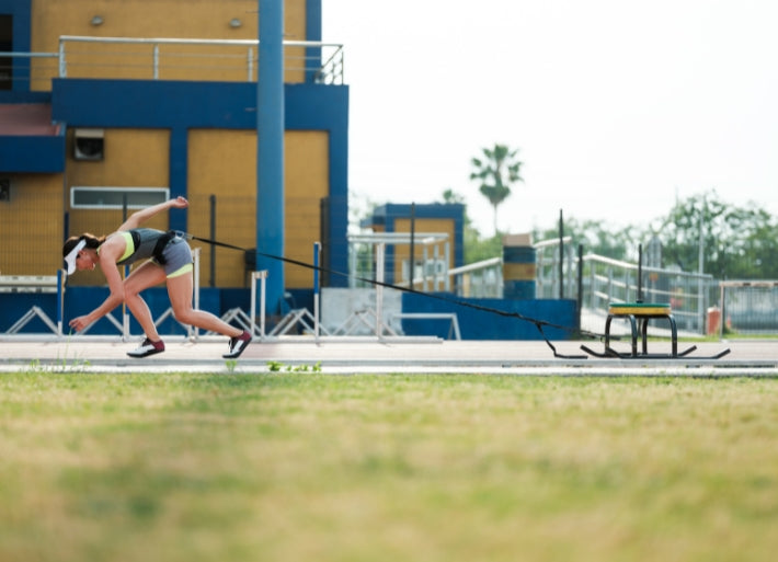 Female Sprinter Training with Power Sledge