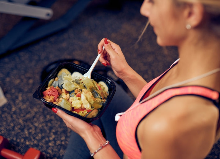 Athletic Woman Easting Healthy Food