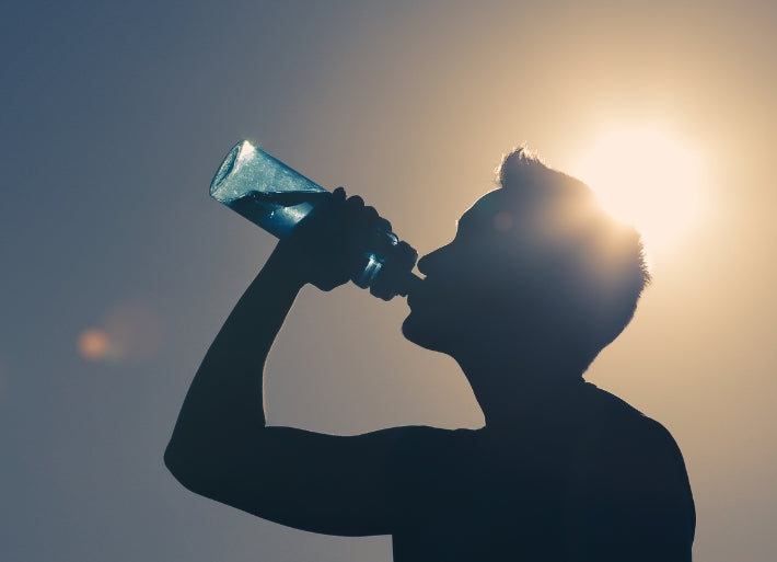 Male athlete drinking water