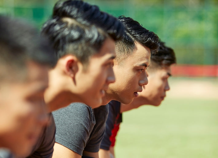 Young male sprinters on starting line