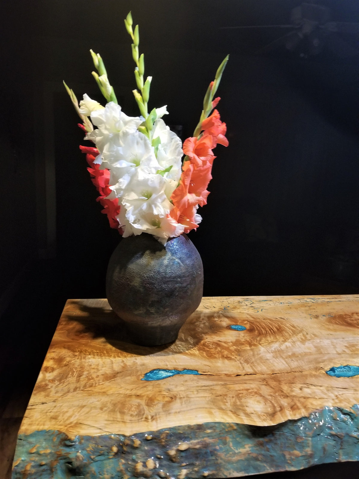 Maple burl and resin table with vase and flowers