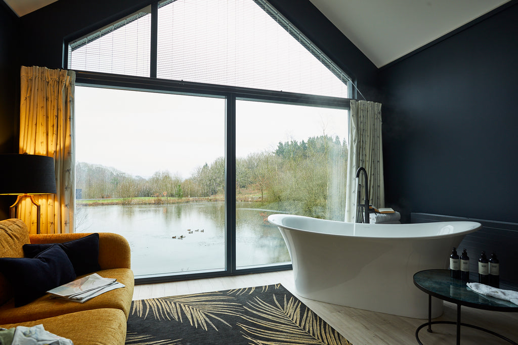 Photograph of luxury bathroom with lakeside view.