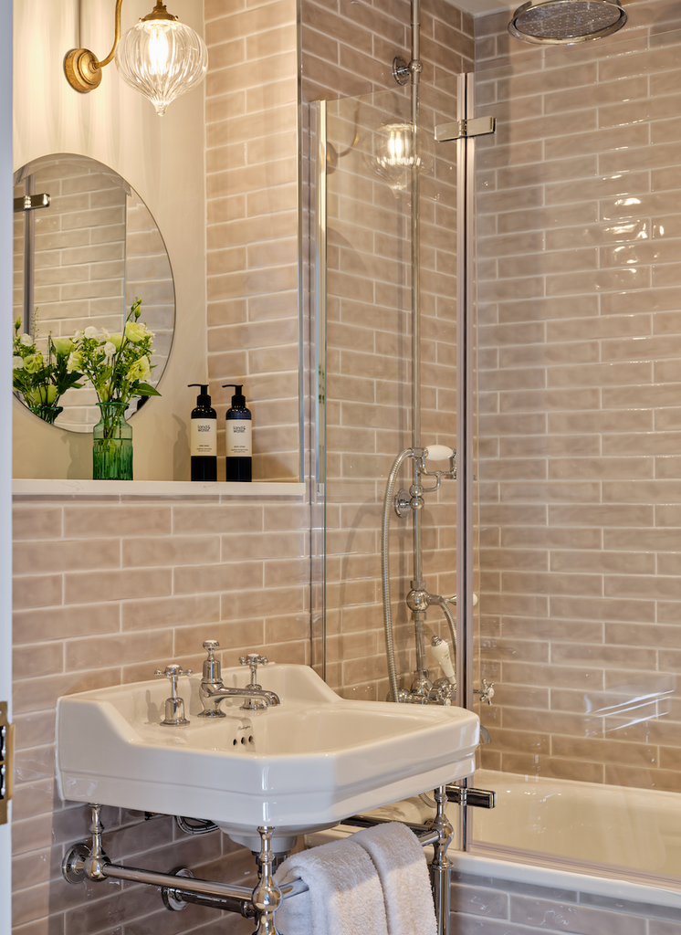 Edwardian sink and oat coloured tiles in bathroom at Stanwell House Hotel. land&water products sit a atop the sink.