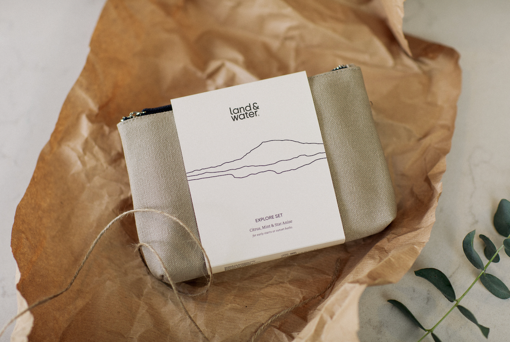 The land&water Explore Set in cotton pouch, opened up from brown paper wrapping and string.