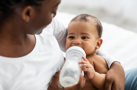 Black mom feeding her baby a bottle