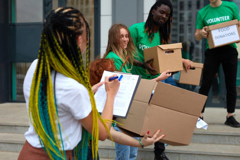 Image of diverse group of young adults volunteering at a food bank