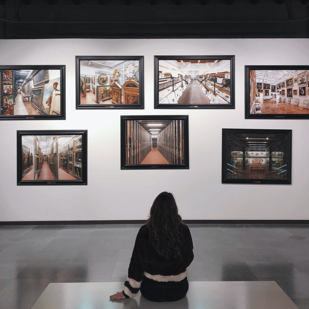 person sitting in front of wall of pictures