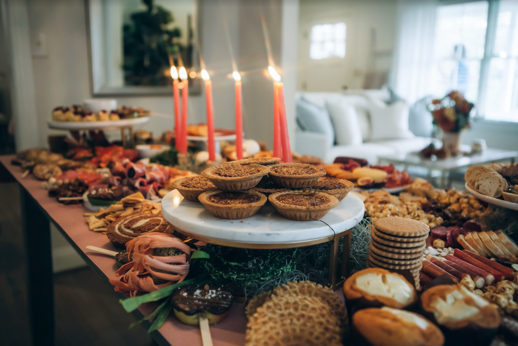 fall-themed table filled with food and candles