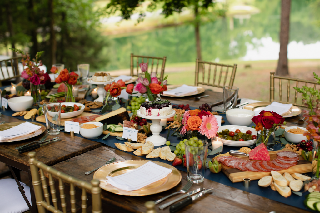 table with place settings, floral arrangements, and food displayed