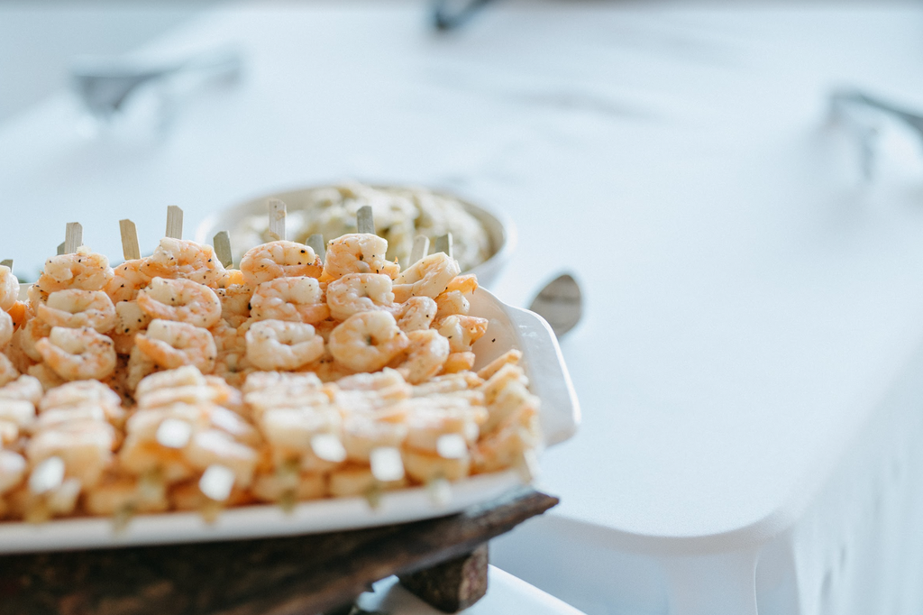 plate of shrimp skewers stacked on top of one another