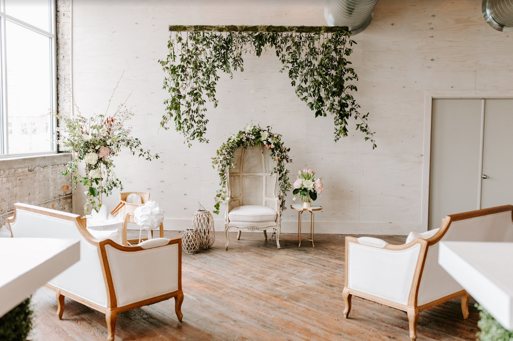 chairs in large room decorated with plants