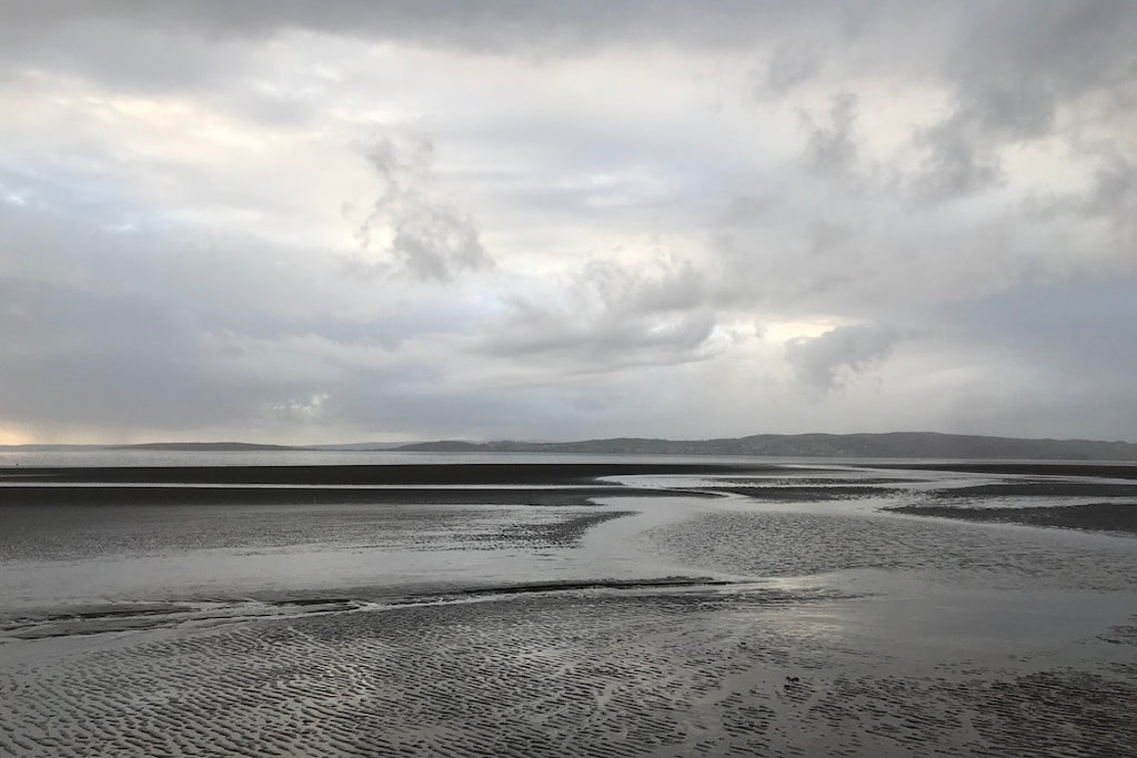 Silver grey mudflats and sky at dusk