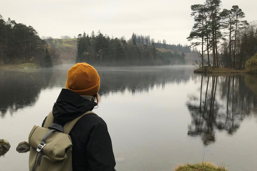 Woman hiker admiring view over Tarn Hows