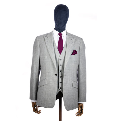 Berry Pink Knitted tie and pocket square with grey suit on a mannequin - centre