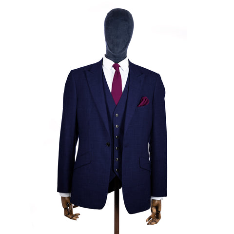 Berry Pink Knitted tie and pocket square with navy suit on a mannequin - centre