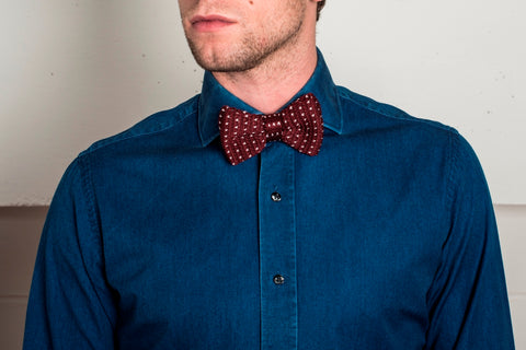 red knitted bow tie and denim shirt